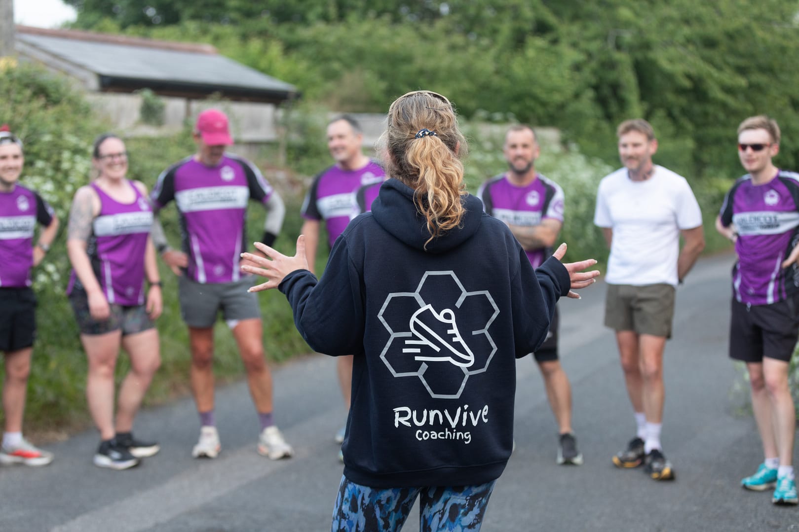 running coach talking to runners