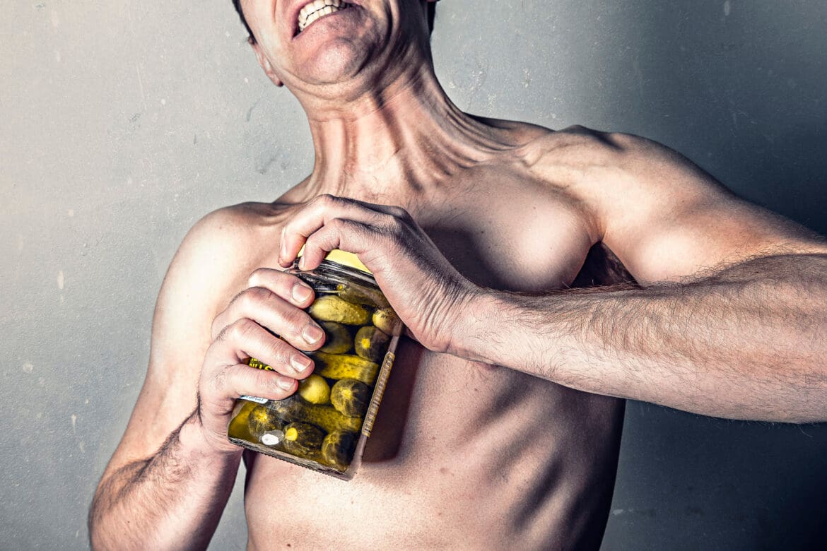 Man opening jar of pickles