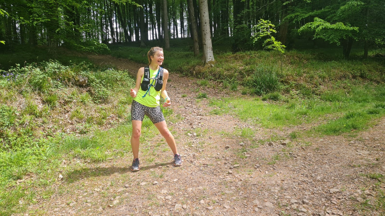Female runner smiling in the woods