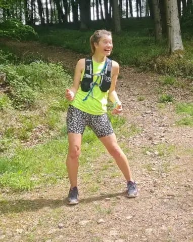 Female trail runner giving thumbs up