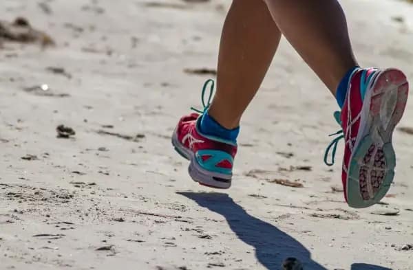 runner on sandy path motivated by running coach