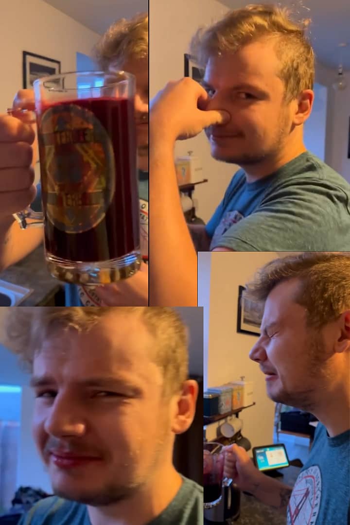 man drinking beetroot not enjoying it