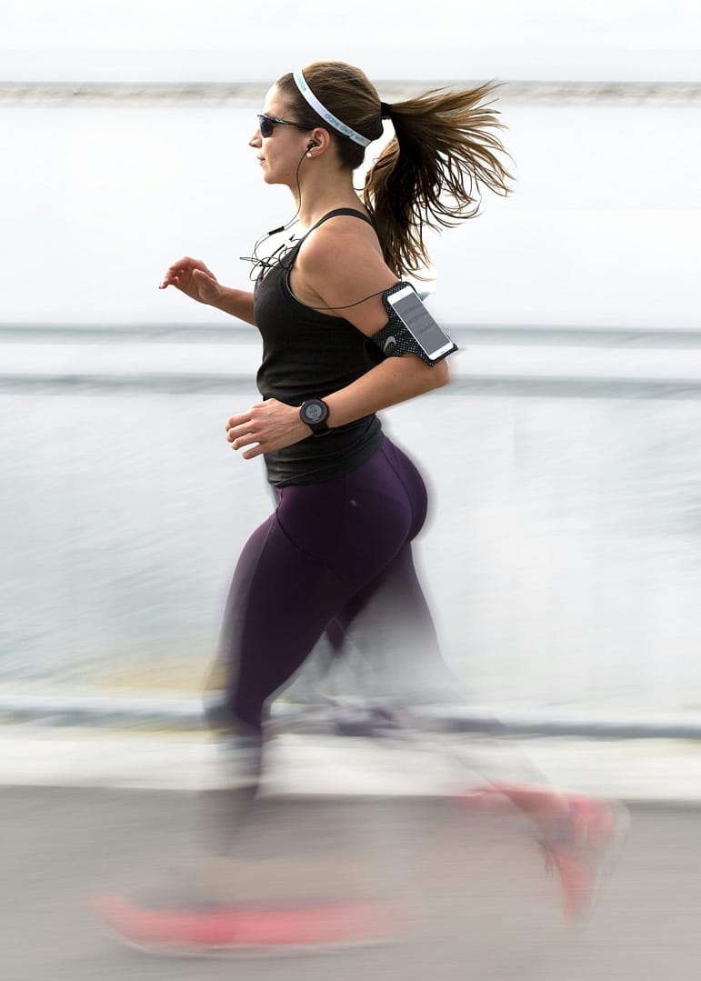 Woman easy running with headphones on
