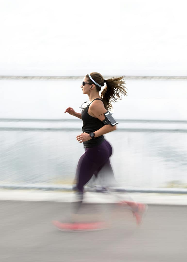 Woman easy running with headphones on