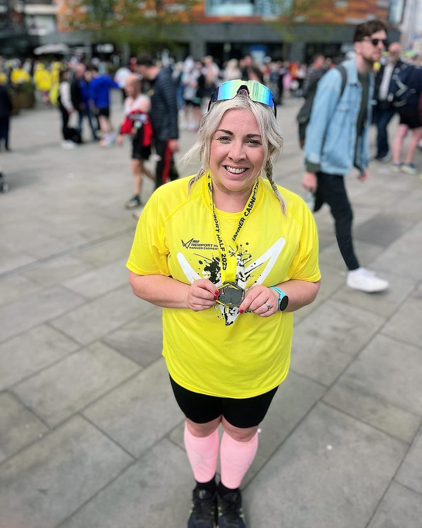 Female runner smiling with medal
