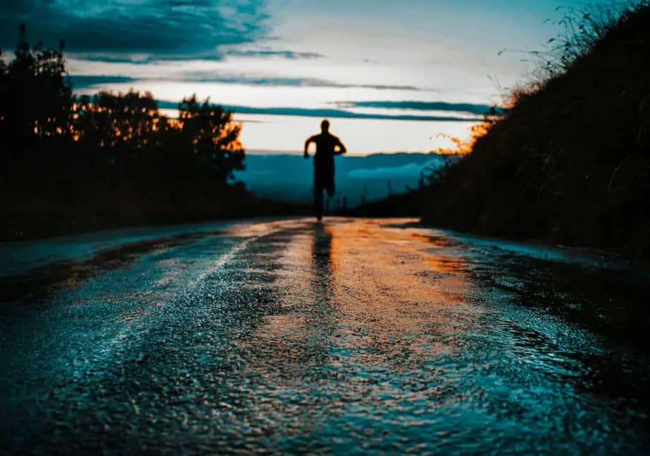 man running on road at night