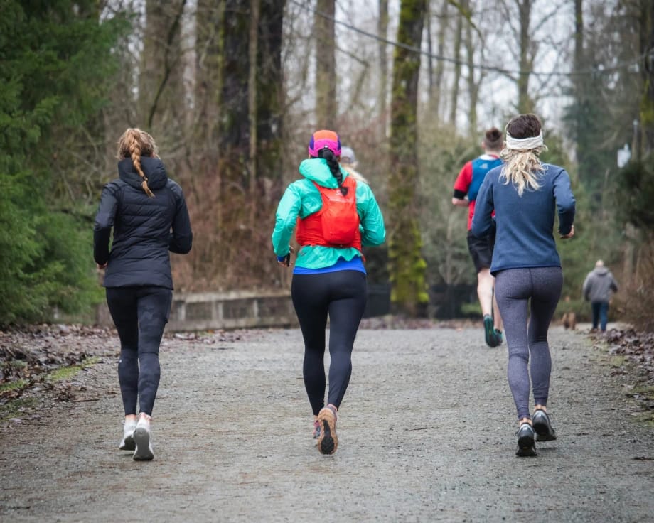 women running on woodland track