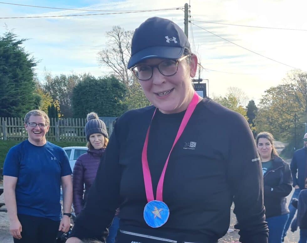 Runner smiling with medal