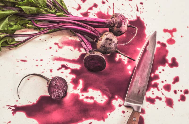 sliced beetroot next to knife with juice