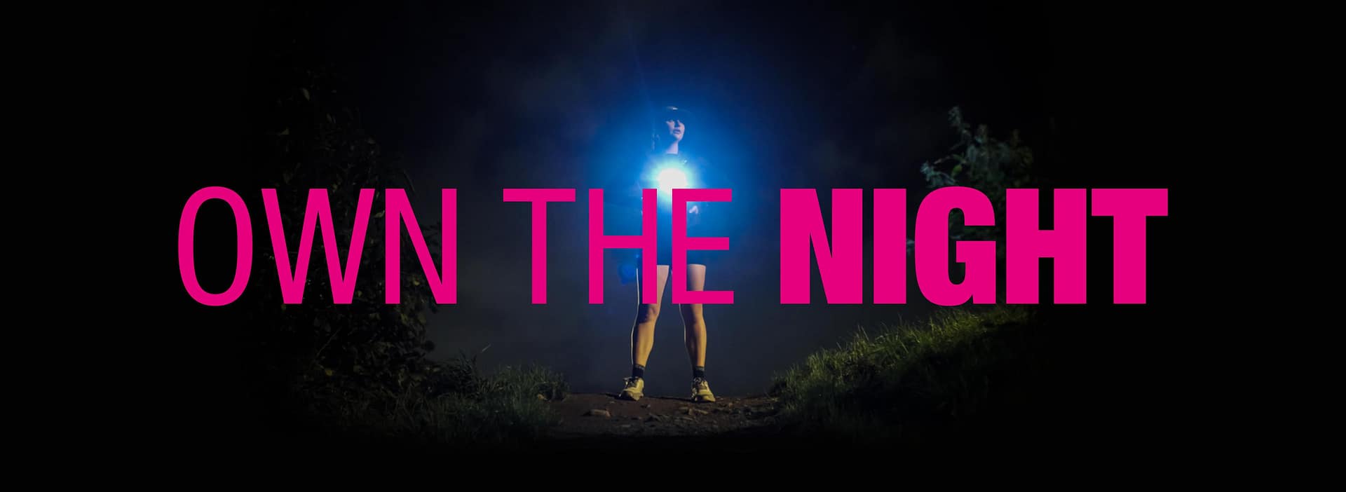 Women running at night with own the night written